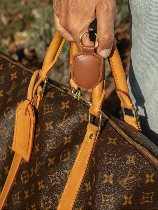 Tan leather key fobs hanging from a set of keys
