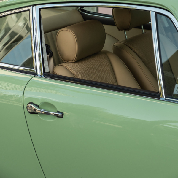 Tan seats viewed through the window of a green Revolt Electric