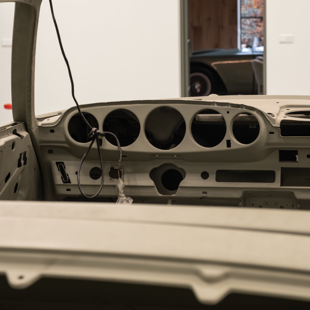 Stripped dashboard and vehicle body during restoration