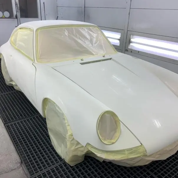 Masked vehicle body shell in a paint booth